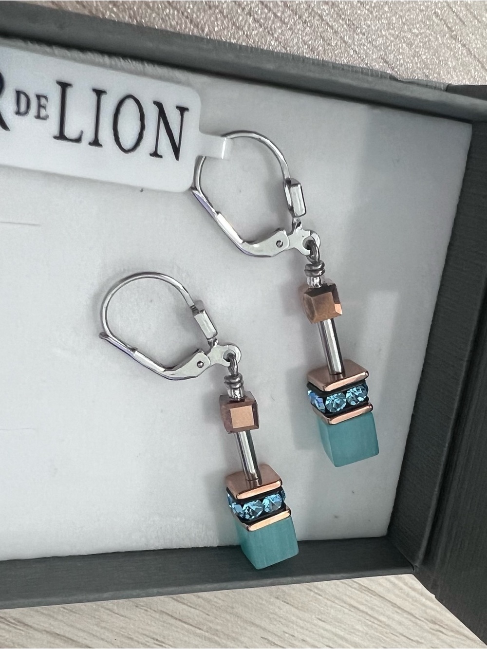 Court de lion earrings. New with tags and box. Gold, silver, blue, and teal.